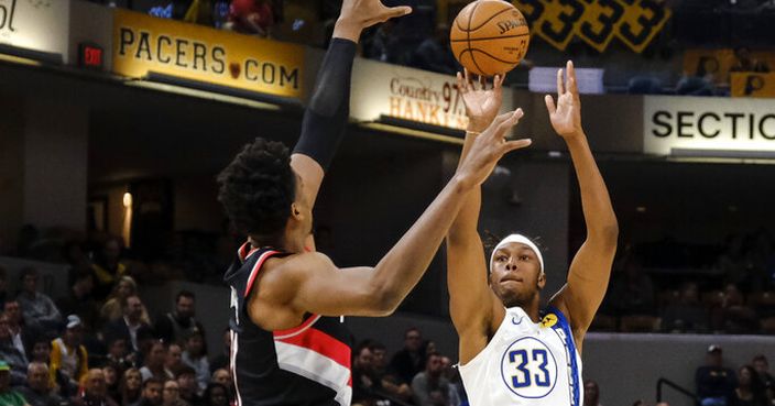 Indiana Pacers center Myles Turner, right, shoots over Portland Trail Blazers center Hassan Whiteside during the second half of an NBA basketball game in Indianapolis, Thursday, Feb. 27, 2020. (AP Photo/AJ Mast)