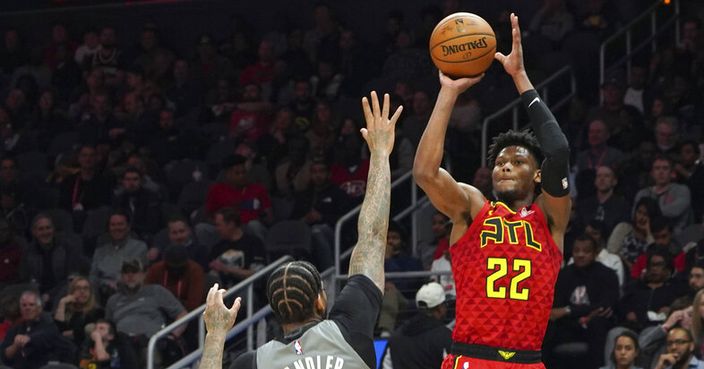 Atlanta Hawks' Cam Reddish (22) shoots for three points over Brooklyn Nets' Wilson Chandler (21) in the second half of an NBA basketball game Friday, Feb. 28, 2020, in Atlanta. (AP Photo/Tami Chappell)
