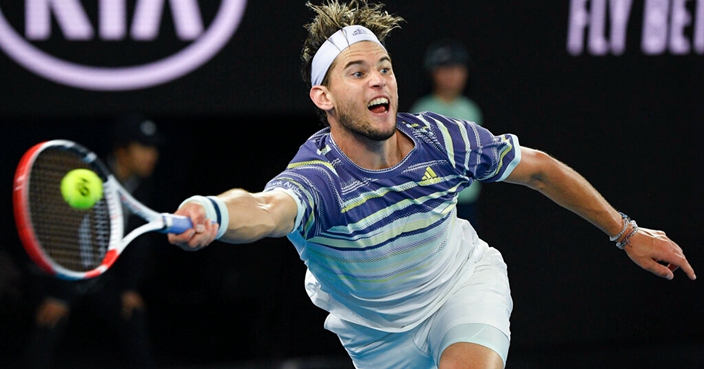 Austria's Dominic Thiem makes a forehand return to Serbia's Novak Djokovic during the men's singles final at the Australian Open tennis championship in Melbourne, Australia, Sunday, Feb. 2, 2020. (AP Photo/Andy Brownbill)