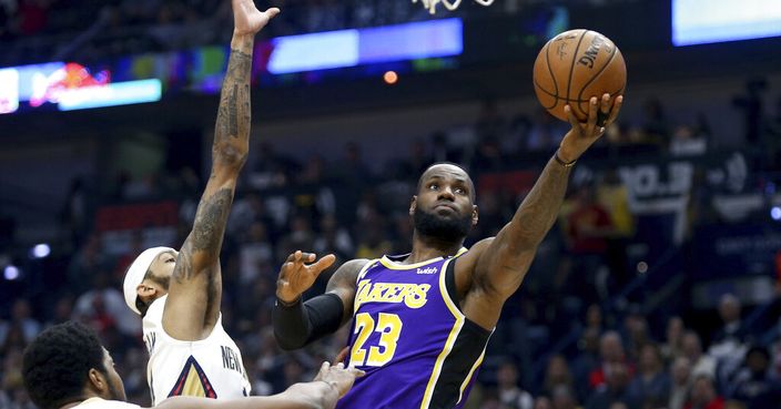 Los Angeles Lakers forward LeBron James (23) goes up for a layup as New Orleans Pelicans forward Brandon Ingram defends in the first half of an NBA basketball game in New Orleans, Sunday, March 1, 2020. (AP Photo/Rusty Costanza)