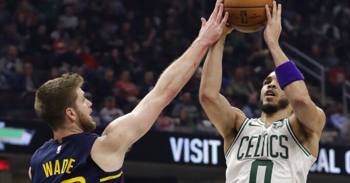 Boston Celtics' Jayson Tatum (0) drives to the basket against Cleveland Cavaliers' Dean Wade (32) in the first half of an NBA basketball game, Wednesday, March 4, 2020, in Cleveland. (AP Photo/Tony Dejak)