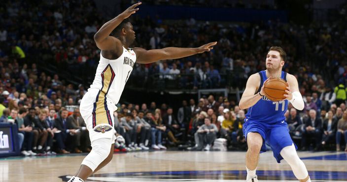 Dallas Mavericks guard Luka Doncic (77) prepares to shoot as New Orleans Pelicans forward Zion Williamson defends during the first half of an NBA basketball game in Dallas, Wednesday, March 4, 2020. (AP Photo/Michael Ainsworth)