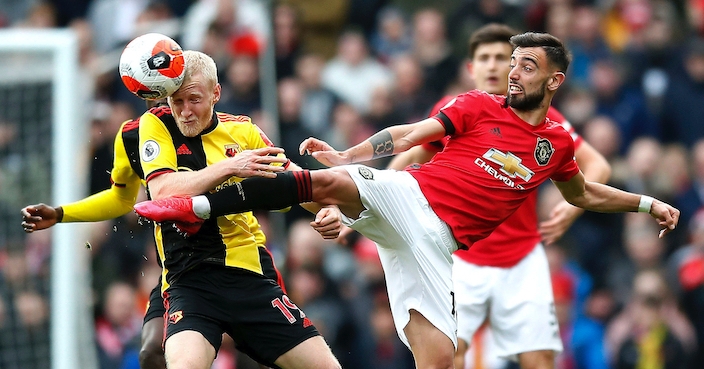 Watford's Will Hughes (left) and Manchester United's Bruno Fernandes (right) battle for the ball during the Premier League match at Old Trafford, Manchester. PA Photo. Picture date: Sunday February 23, 2020. See PA story SOCCER Man Utd. Photo credit should read: Martin Rickett/PA Wire. RESTRICTIONS: EDITORIAL USE ONLY No use with unauthorised audio, video, data, fixture lists, club/league logos or 
