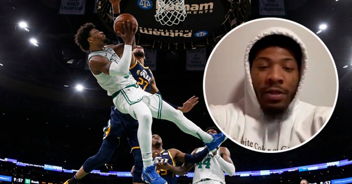 Boston Celtics' Marcus Smart is knocked off balance while going for a shot against Utah Jazz's Rudy Gobert (27) during the fourth quarter of an NBA basketball game Friday, March 6, 2020, in Boston. (AP Photo/Winslow Townson)