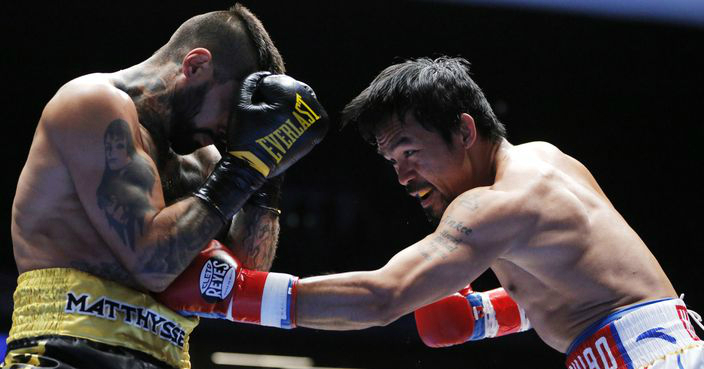 Manny Pacquiao of the Philippines, right, Lands a punch at Lucas Matthysse of Argentina during their WBA World welterweight title bout  in Kuala Lumpur, Malaysia, Sunday, July 15, 2018. Pacquiao won the WBA welterweight world title after knocking out Matthysse on round seven. (AP Photo/Yam G-Jun)