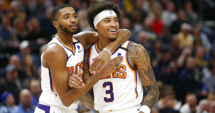Phoenix Suns forward Mikal Bridges, left, and forward Kelly Oubre Jr. (3) react to a foul called on Oubre in the first half during an NBA basketball game against the Utah Jazz, Monday, Feb. 24, 2020, in Salt Lake City. (AP Photo/Rick Bowmer)