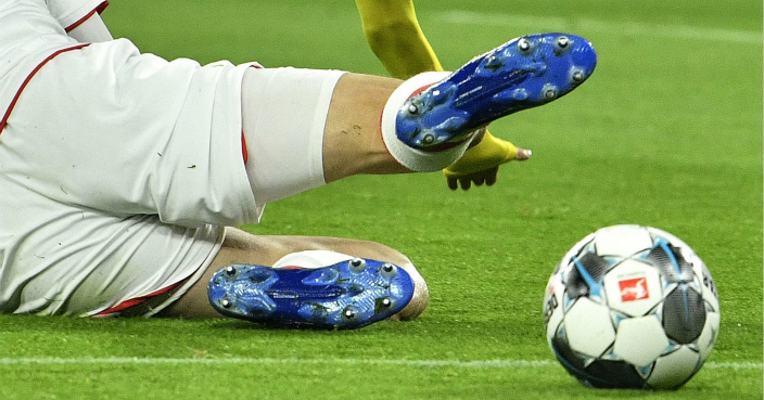 Cologne's Sebastiaan Bornauw, down, fouls Dortmund's Achraf Hakimi during the German Bundesliga soccer match between Borussia Dortmund and 1. FC Cologne in Dortmund, Germany, Friday, Jan. 24, 2020. (AP Photo/Martin Meissner)