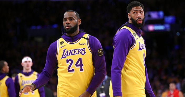 Los Angeles Lakers' LeBron James, left, and Anthony Davis warm up while wearing jerseys with the No.s 24 and 8, respectively, in honor of Kobe Bryant, prior to the team's NBA basketball game against the Portland Trail Blazers in Los Angeles, Friday, Jan. 31, 2020. (AP Photo/Kelvin Kuo)