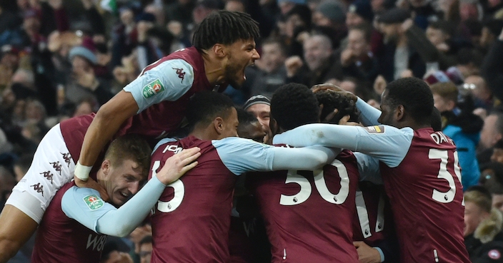 Aston Villa's Trezeguet is mobbed by his teammates after he scored his sides 2nd goal of the game during the English League Cup semifinal 2nd leg soccer match between Aston Villa and Leicester City and at the Villa'Park in Birmingham, England, Tuesday, Jan. 28, 2020. (AP Photo/Rui Vieira)