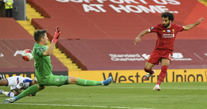 Liverpool’s Mohamed Salah scores his side’s second goal during the English Premier League soccer match between Liverpool and Crystal Palace at Anfield Stadium in Liverpool, England, Wednesday, June 24, 2020. (Shaun Botterill/Pool via AP)