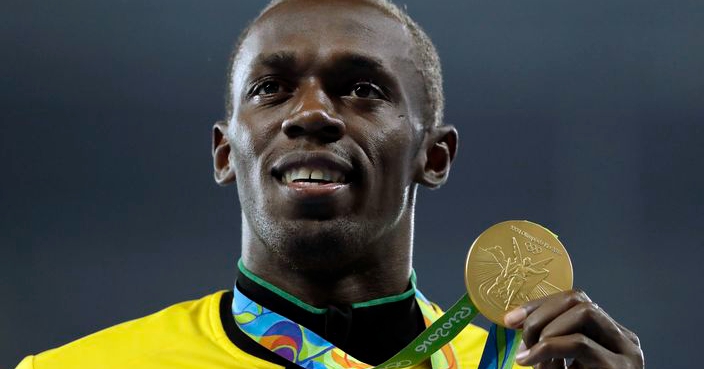 FILE - In this Aug. 19, 2016 file photo gold medal winner Jamaica's Usain Bolt holds his medal after the award ceremony for the men's 200-meters during the athletics competitions of the 2016 Summer Olympics at the Olympic stadium in Rio de Janeiro, Brazil. Bolt failed to make it to the finishing line in his last race. The Jamaican great crumpled on the track with a left leg injury as he was chasing gold in the 4x100-meter relay at the world championships in London. (AP Photo/Jae C. Hong, file)