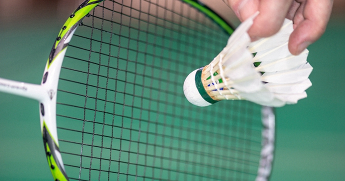 serve badminton with a shuttlecock